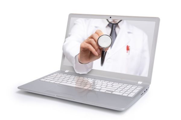 Telemedicine concept. Doctor with a stethoscope on the computer laptop screen