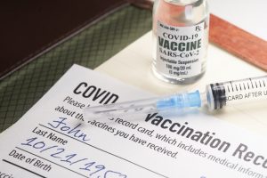 How should employers handle unvaccinated workers?