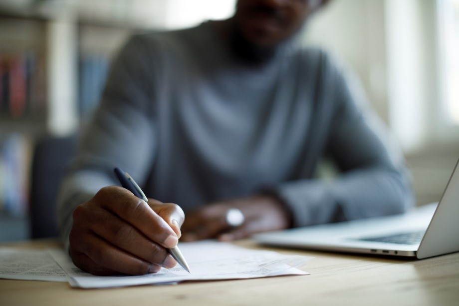 Man is shown writing.