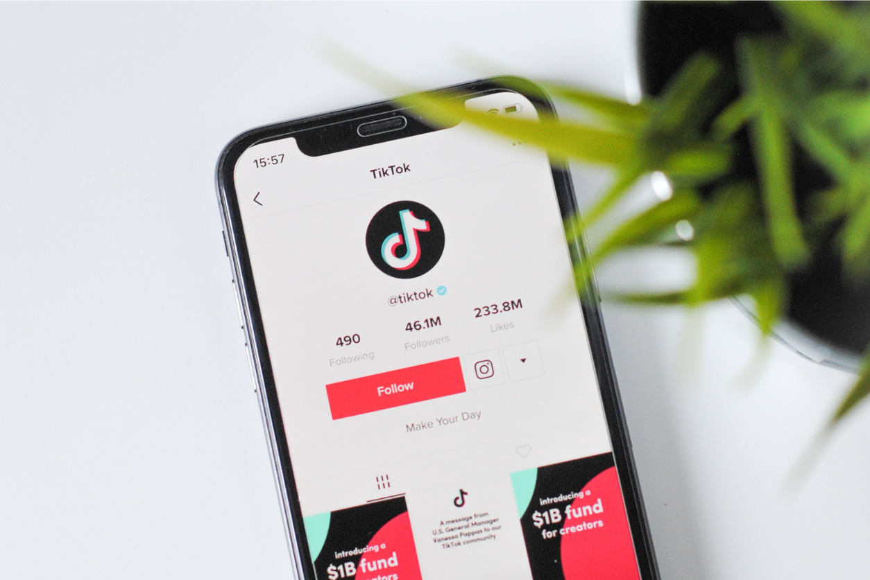 An image showing the top view of a phone displaying TikTok's main account on the platform for an article about tiktok tactics for social media success. Photo by Nik on Unsplash.