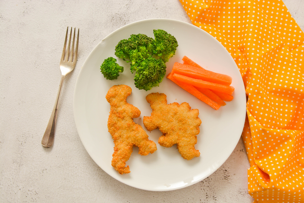 Kids food. Dinosaur shaped chicken, fish or turkey nuggets, ready to eat. Green Giant and Corn Kid joined forces during an "That's Giant" campaign.