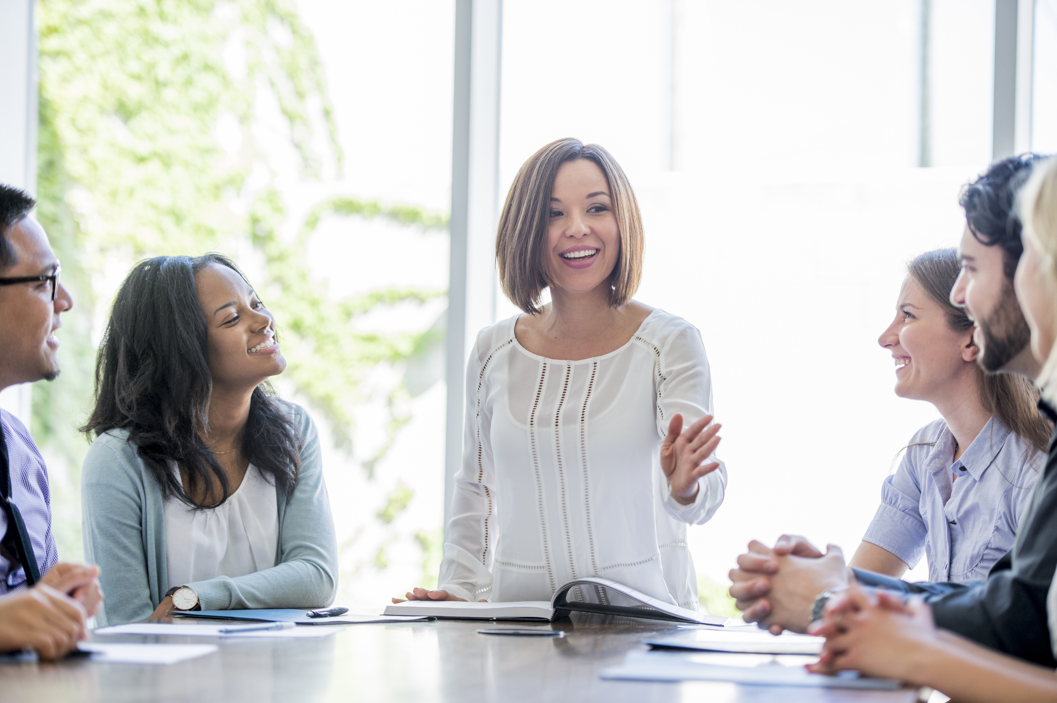 Diverse group of professionals brainstorm together.