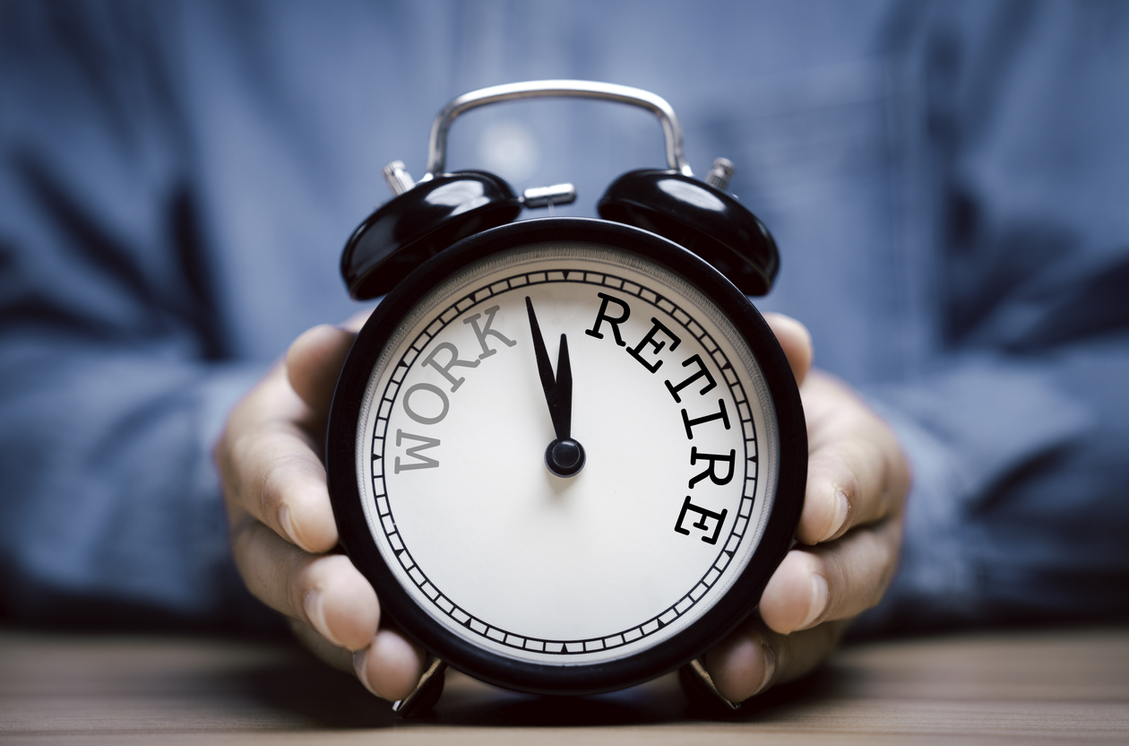 Businessman holding black alarm clock with clockwise countdown from work to retirement. Mitch McConnell's health woes are causing retirement murmurings.