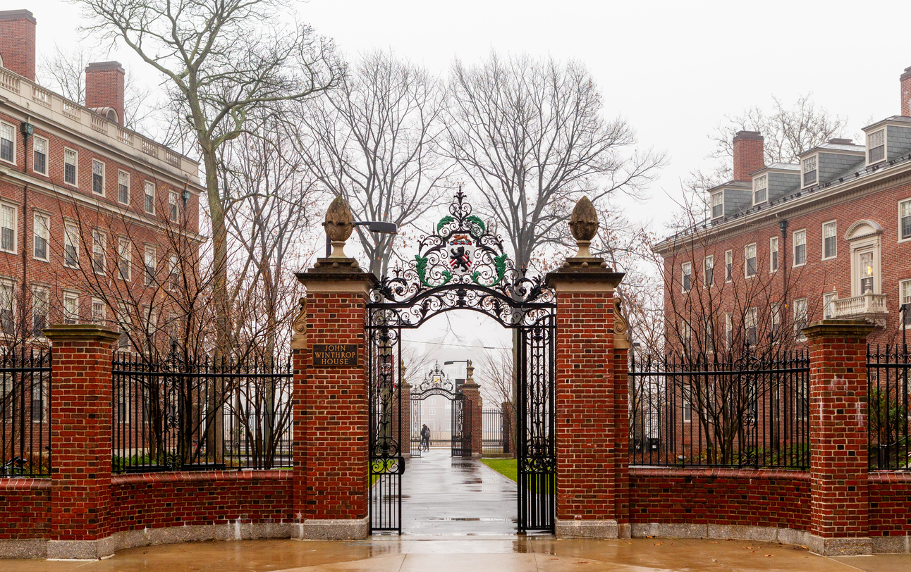 Cambridge, Massachusetts, USA - December 11, 2021: The John Winthrop House and gate in Harvard Yard on a rainy day. Winthrop is one of twelve undergraduate residential Houses at Harvard University. It is home to approximately 400 upperclass undergraduates. Winthrop house consists of two buildings, Standish Hall and Gore Hall built in 1912. In 1931 they were joined as John Winthrop House. The House crest atop the gate shows a lion on a shield with chevrons in the background. Harvard president Claudine Gay was slow to respond to Israel Hamas war.