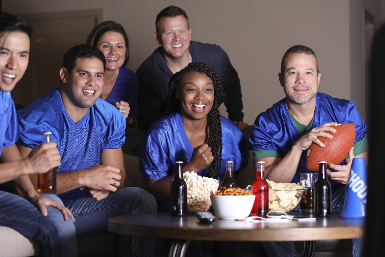 A stock photo of people watching the Super Bowl at a party