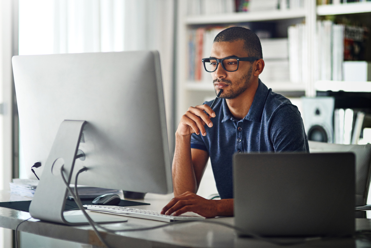 Cropped shot of a businessman using his computer in his home office